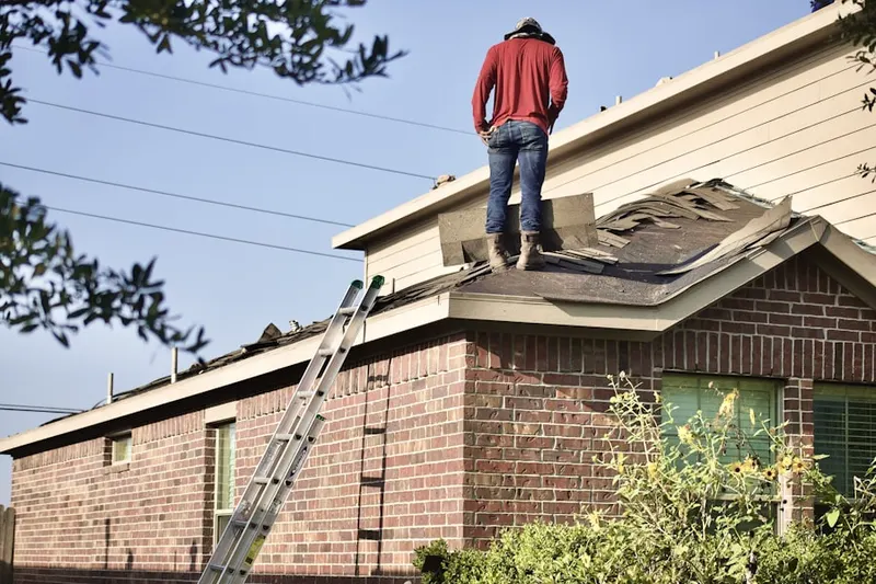 Professional roofer working on a residential roof in Yorklyn